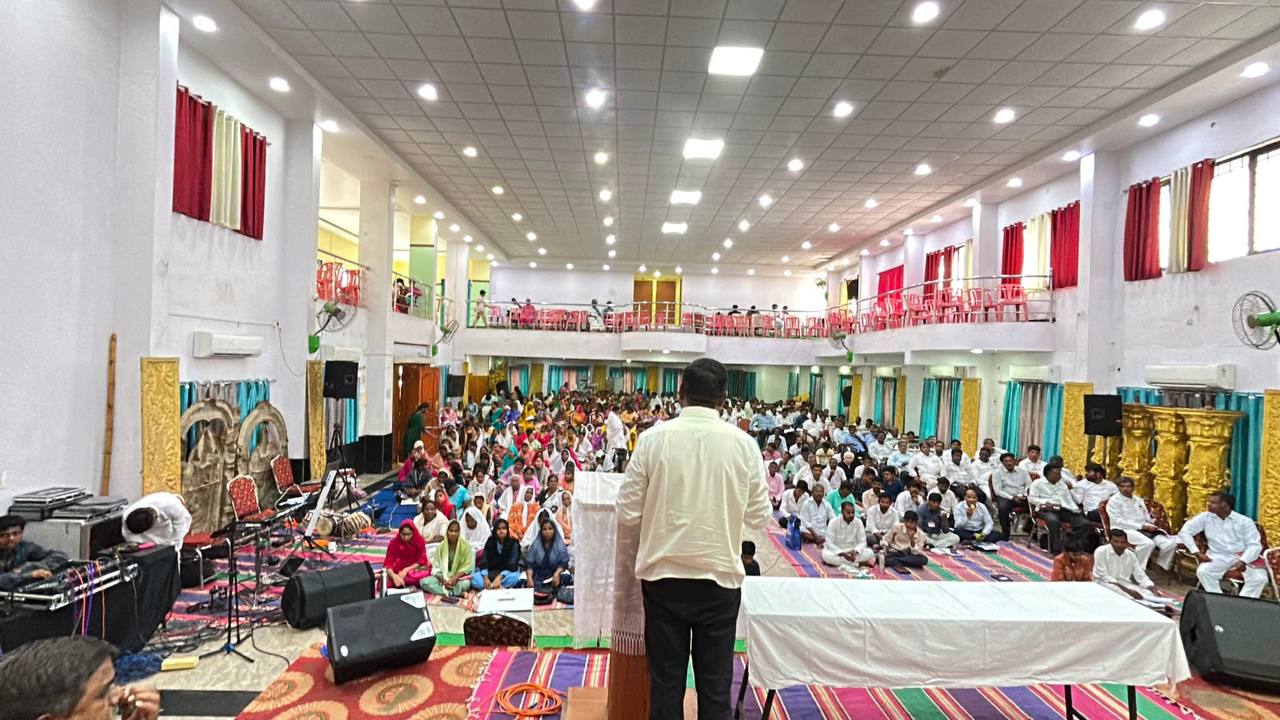 The hall seen from the platform with believers seated across the floor